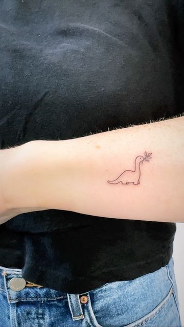 Simple Tattoos Dinosaur, Highland Cow Fine Line Tattoo, Small Dinasour Tattoos, Dinosaur Tattoo Line Art, Dinosaur Simple Tattoo, Tiny Dino Tattoo Cute, Fine Line Tattoo Dinosaur, Dino Line Tattoo, Dinsors Tattoo