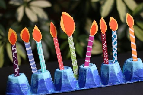 This egg carton menorah with its painted popsicle stick candles is fun and easy for kids to make. It's a great way to teach toddlers and preschoolers about Hanukkah and to allow them to light their own "candles" every night during the holiday. #HappyHooligans #Hanukkah #Craft #Menorah #EggCarton #PopsicleStick #Candles #Toddlers #Preschoolers Candle Crafts For Kids, Hanukkah Activities Preschool, Menorah Craft, Chanukah Crafts, Chanukah Decorations, Hanukkah Preschool, Hanukkah Activities, Hannukah Crafts, Hanukkah Ideas