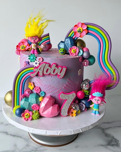 Colorful Trolls-themed tall birthday cake Trolls Themed Birthday Cake, Trolls Birthday Party Ideas Cake, Troll Birthday Cakes, Trolls Cake Ideas, Tall Birthday Cake, Trollstice Birthday Party, Trolls Sheet Cake, Poppy Trolls Cake, Poppy Cake Trolls