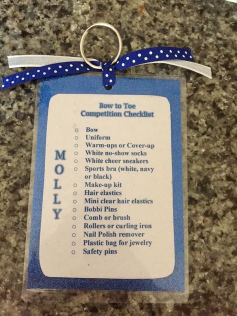 Bag tag/checklists for my daughter's cheer team. Made using paper, 4x6 thermal laminator pouches, key rings and ribbon. Cheer Bag Tag Ideas, Cheer Gift From Coach, Competitive Cheer Gifts For Team, Color Guard Team Bonding, Cheer Comp Checklist, Cheer Competition Checklist, Cheer Bag Checklist, Team Gifts Cheerleading, All Star Cheer Gifts Ideas