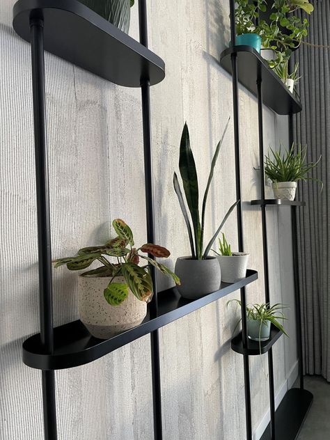 This unique shelving unit, held up by 5 steel pillars, comes with 7 floating shelves. Move them up or down, or reorganize the whole layout and place the shelves any way you prefer. Unit can be installed straight along a wall, as a room divider or set inside or outside of a corner. Additional pillars and shelves are available, so this unit can be made to fit along any wall you choose. Even turn it and have the unit go around a corner or curve. Standard Pillars fit 9' ceiling. Additional options a Luxury Shelves, Floor To Ceiling Shelving, Industrial Shelf, Black Plant Shelves, Wall Display Shelves, Hanging Plant Shelf Room Divider, Master Bath Decor Ideas, Recessed Wall Shelves, Gothic House Wall Shelves