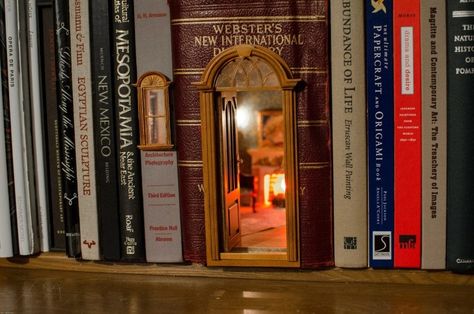 This room inside a dictionary with a soothing glow coming from it. 15 Photos Of Book Nook Shelf Inserts That Might Inspire Your Next DIY Craft Project Bookshelf Art, Book Origami, Miniature Rooms, Fairy Book, Fairy Doors, Book Nook, Miniature Houses, Miniature Books, Room Box