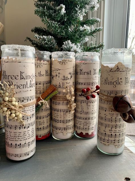 Please see below for colors, add your request in the personalization note. These 8in tall candles are perfect for your holiday decor! Choose between 7 vintage sheet Christmas music types and varying colors. The sheet music is hand dyed and encrusted on the candles and every strung on addition is specifically curated to add on extra pizazz to each candle. Deck The Halls - 2 Red First Noel - 1 Red Away in a Manger - 1 Red Jingle Bells - 2 White 3 Kings - 1 White Silent Night - 2 Red O Come All Ye Lds Christmas Party Table Decorations, Sheet Music Decorations, Sheet Music Christmas Crafts, Dollar Tree Lanterns Diy Christmas, Country Christmas Centerpieces For Table, Christmas Centerpiece With Candles, Christmas Centerpieces Simple, Christmas Candlesticks Ideas, Inexpensive Christmas Centerpieces