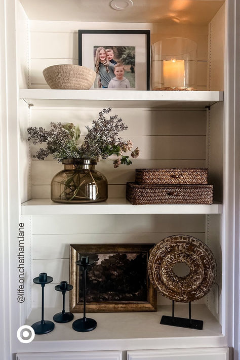 Spruce up your space with a modern-rustic vibe you�’ll love for seasons to come. Mix & match textured decor accents. Add a glass vase with faux flowers to make your space extra cozy. P.S. Add these to your entryway, bookshelf or your dresser to liven up any corner. Fall Shelf Decor Ideas, Built In Shelf Decor, Cabinet Styling, Apartment Finds, Shelf Decor Living Room, Styling Shelves, Room Vibes, Bookcase Decor, Bookshelf Styling