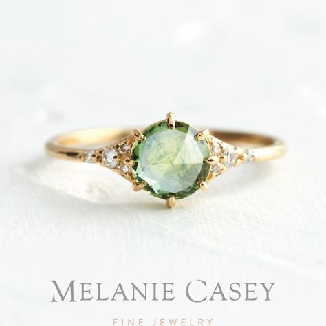 The Honeydew Rose Cut Sapphire Lady's Slipper features a pale green rose cut Montana sapphire set in 14k yellow gold and accented by sparkling white diamonds. Find this delicate, unique engagement ring at melaniecasey.com! Pale Sapphire Engagement Ring, Pale Green Engagement Ring, Creative Rings, Earth Engagement Rings, Creative Engagement Rings, Traditional Rings, Promise Jewelry, White Gold Bridal Set, Montana Sapphire Ring