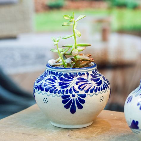 Exemplifying exceptional craftsmanship and unmatched beauty, this vibrant ceramic flower pot is truly captivating thanks to its meticulously hand-painted floral and leaf motifs in an exquisite lapis hue against an off-white background. Mexicos Isabelle Collins draws inspiration from traditional Talavera techniques to craft this fabulous planter that will elevate any interior design scheme. Mexican Pottery Vase, Diy Talavera Pottery, Blue Pottery Decor, Painting Pot Ideas, Mexican Pottery Designs, Mexican Vases, Mexican Ceramics Pottery, Mexican Pots, Mexican Pottery Decor