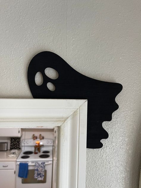 "Get ready for Halloween vibes with this charming custom wood corner silhouette for your doors! This ghost wood sign will elevate your Fall and Halloween decor. With this exquisite door corner accent crafted from plywood, delicately laser-cut to a sleek 1/8 inch thickness and elegantly lacquered in black, your Halloween decor is sure to be the envy of the neighborhood. Embrace the spirit of the season by adding this unique ghost decor to your doors, pictures, wall hangings, and more - we've painted both sides for your creative freedom. Crafted with care by our tight-knit family business nestled in Texas, each custom wood sign is a testament to our dedication. 💖 Delve into the Details: - Material: Laser-cut plywood - Dimensions: 8.25\" wide X 8.25\" tall Each piece will be slightly differe Diy Halloween Wood Cutouts, Halloween Cnc Project, Cnc Halloween Projects, Halloween Wooden Yard Cutouts, Seasonal Wood Crafts, Diy Wooden Halloween Decorations, Laser Cut Halloween Decor, Wooden Halloween Decor, Cricut Halloween Decor