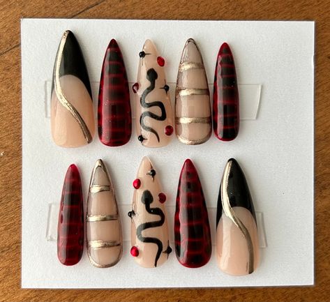 Looking for something a little more dark and moody? This snake set is perfect! Red and black croc nails mix with the hints of chrome, making this one killer set. Shown on medium stilettos.  Each set comes with nail glue, a mini buffer block, a cuticle pusher and an alcohol wipe for optimal prep before applying the nails. All products used are Beetles gel polish brand. Avoid inhalation, ingestion, and eye contact. If irritation or allergic signs occurs, stop use immediately. If signs persist, see Black Croc Nails, Texture Nails, Croc Nails, Snake Nails, Beetles Gel Polish, Animal Texture, Gel Polish Brands, Maroon Nails, 2024 Halloween