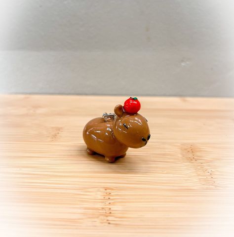 "Capybara with Apple keychain  This keychain is made from polymer clay and varnished with resin for extra durability and shine. However, please keep in mind that it is handmade so gentle use is still recommended. There may be imperfections due to the nature of it being handmade.  Dimensions: Length: approx 1.5\"  Height: approx 1.25\" I am still new to the world of polymer clay and I am learning every day. Any feedback regarding my products is greatly appreciated. Thank you!" Nature, Fimo, Polymer Clay Capybara, Capybara Clay Art, Clay Capybara, Capybara Clay, Polymer Clay Keychains, Apple Keychain, Aesthetic Minecraft