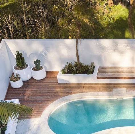 Modern Coastal Pool Area, Pool Area Renovation, Curved Pool Landscaping, Update Pool Area, White Pool Decking, Backyard Inspo With Pool, Oval Pool Landscaping, Modern Kidney Shaped Pool, Coastal Pool Landscaping