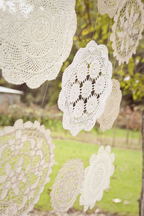 hanging doilies- attached on the vintage doors behind our sweetheart table Doily Decor, Doily Garland, Shabby Chic Wedding Decor, Boda Diy, Bottle Tree, Budget Friendly Wedding, Wedding Ceremony Backdrop, Mini Bottle, Diy Backdrop