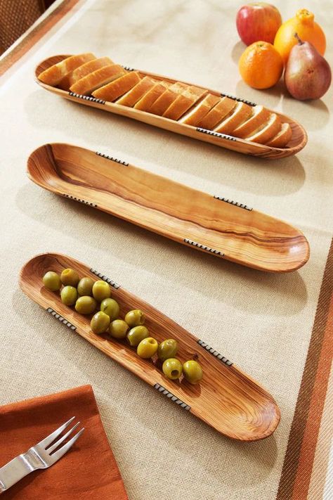 Hand carved from wild olive wood by Kamba carvers living in Eastern Kenya, these all-natural trays are sized perfectly for serving up baguettes and crackers. Dyed cow bone inlay adds a distinctively African touch. Natural wood grain and bone inlay will vary. Wooden Cups, Wood Serving Platter, Wood Trays, Wood Dishes, Wild Olive, Wooden Salad Bowl, Wooden Dishes, Wood Utensils, Wood Serving Board