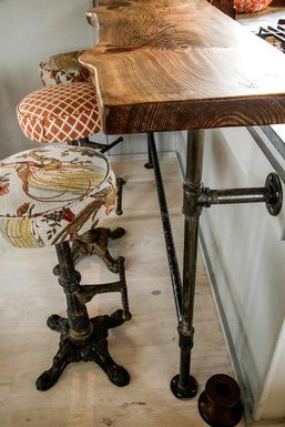 The breakfast counter is simply a wood slab that sits on a thrifty but attractive base made of plumbing pipes. Swiveling iron stools were scored at the Long Beach flea market for $200 and then upholstered in outdoor fabric. Island Bars, Iron Stools, Budget Design, Revere Pewter, Pipe Furniture, Plumbing Pipes, Kitchen Islands, Wooden Table, Bar Furniture