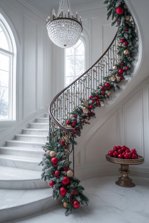 Transform your staircase with lush garlands and vibrant ornaments for stunning Christmas home decor. Elevate your festive spirit with these classic red and gold accents that perfectly complement your elegant space. #ChristmasHomeDecor #FestiveStaircase #HolidayElegance Double Staircase Christmas Decor, Holiday Decor Stairs, Christmas Bannister Decorations, Indoor Railing Christmas Decoration, Garland On Bottom Of Staircase, Christmas Deco Stairs, Christmas Swag On Staircase, Stunning Christmas Decor, Grand Staircase Christmas Decor