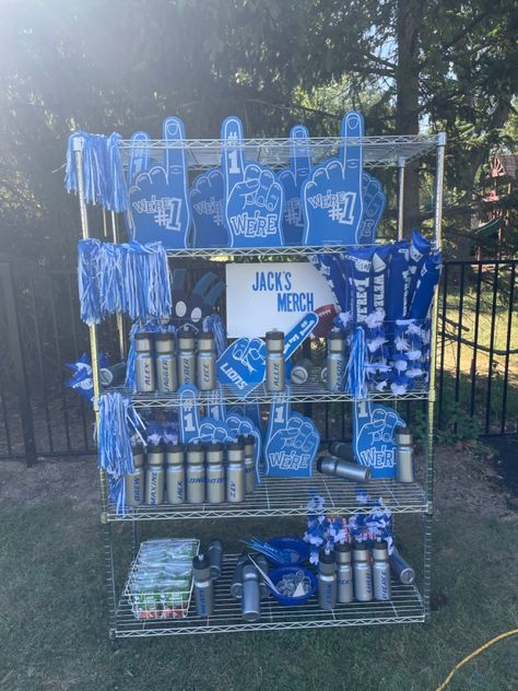 Merch stand for Football themed party University Themed Party, Concert Merch Display, Merch Stand Ideas, School Spirit Store Ideas, Party Favor Display Ideas, School Merch Ideas, Brand Merchandise Ideas, Birthday Merch, Merch Stand