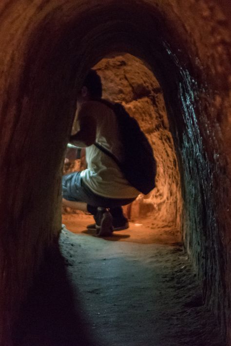 Image of a person exploring the Cu Chi Tunnels in Ho Chi Minh City, Vietnam