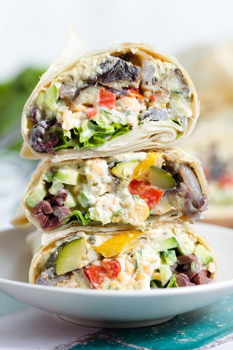 If you're looking for a vegetarian lunch or light dinner, try this Mediterranean Veggie Wrap! It's made with mashed chickpeas with tangy tzatziki sauce, creamy hummus, roasted colorful veggies, and fresh lettuce. This wrap is super versatile so you can add things or leave them out based on your preference. It's delicious any time of the year whenever you want to add some extra veggies to your diet! Mediterranean Veggie Wrap, Mediterranean Wrap Recipes, Mashed Chickpeas, Mediterranean Wrap, Veggie Hummus Wrap, Peach Banana Smoothie, Vegetarian Lettuce Wraps, Vegetarian Wraps, Lemon Smoothie