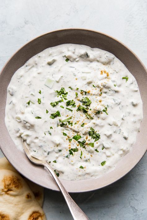 A creamy, cooling Indian yogurt-based condiment, this easy raita recipe makes a refreshing dip or a saucy side dish. We especially love it with spicy, juicy Tandoori chicken. Indian Yogurt Dip, Indian Yogurt Sauce, Easy Raita Recipe, Cucumber Raita Recipe, Tzatziki Recipe, Cucumber Raita, Vegan Tzatziki, Tzatziki Recipes, Dill Dip