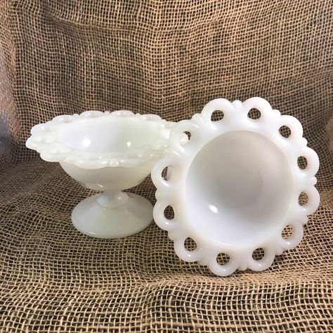 Set  of 2 vintage (1950) milk glass compote dishes  This is a beautiful set with a romantic style, the delicate laced edge make this vintage set a unique addition for your table. In the 1950's these kind of glassware were on a revival, considering the origin of the milk glass dates prior to the 1800's, but after WWII became more popular, hence a few American glass  manufactures made them, those are the pieces people are collecting now a day as art pieces. Perfect for weddings or collectors. Mate Glass Dishware, Milk Glass Centerpiece, Crystal Glassware Antiques, Vintage Dishes Antiques, Antiques Value, Milk Glass Decor, Vintage Glassware Antiques, Milk Glass Collection, Milk Glass Lamp