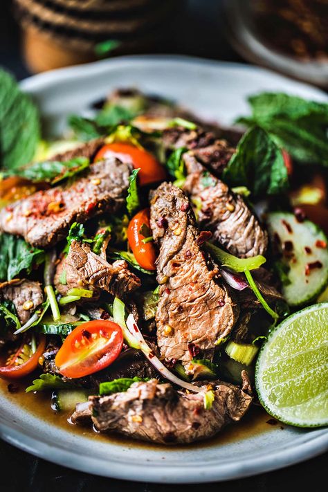 This easy Thai beef salad recipe has fresh summer vegetables, fragrant herbs, lime juice, and fish sauce. Once you gather all your Thai beef salad recipe ingredients, you’ll eat a tasty meal in less than 30 minutes! #thaibeefsalad #thaibeefsaladrecipe #easythaibeefsalad #spicythaibeefsalad #thaibeefsaladrecipes