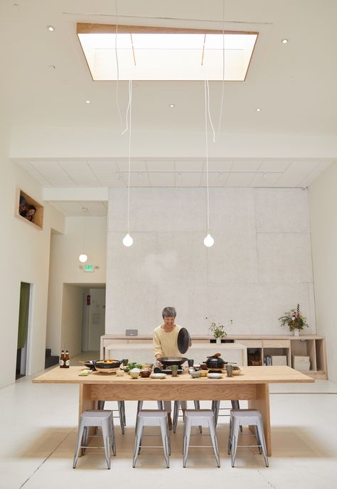 Naoko Takei Moore at the plywood table she uses for cooking classes and workshops. The green curtain at left leads to a small meditation room. Cooking Classes Design, Small Meditation Room, Clay Cooking Pot, Plywood Diy, Kitchen Workshop, Plywood Table, Cnc Furniture, Green Curtains, Japanese Cooking