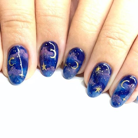 Deep blue galaxy nails with accents of pink clouds and gold stars and moons. This is a slightly more whimsical take on galaxy nails and I highly recommend getting these nails for the winter time. It's a perfect manicure for the chilly gloomy season especially with it's deep color scheme. Tap through for more nail art inspiration from Katie Masters aka nailthoughts #galaxynails #winternails #darknails #nailthoughts Galaxy Nail Art, Galaxy Nails, Smink Inspiration, Star And Moon, Instagram Nails, Cute Nail Art, Dream Nails, Nail Art Inspiration, Valentines Nails