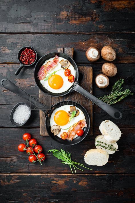 Find Fried eggs with bacon and vegetables in cast iron frying pan, on old dark wooden table background, top view flat lay stock images in HD and millions of other royalty-free stock photos, illustrations and vectors in YAYIMAGES collection. Thousands of new, high-quality pictures added every day. Eggs With Bacon, Wooden Table Background, Dark Wooden Table, Table Background, Cast Iron Frying Pan, Food Art Photography, Art Indian, Food Stations, Food Photography Tips