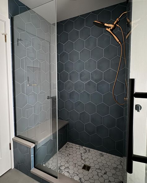 {Kids bathroom reno!! Love this blue tile and the balance of the floor tiles that pull that blue in a little. This is one of our favorite shower fixtures to use when people want a simple hand held and a separate shower head. Makes it really easy to clean the shower when you have the hand held and also great to bathe pups ☺️} Blue Hexagon Shower Tile, Shower Tile Honeycomb, Cool Shower Tile, Walkin Shower Tile Ideas, Large Tile Shower Ideas, Modern Shower Tile Ideas, Purple Farmhouse, Walk In Shower Tile Ideas, Master Shower Tile