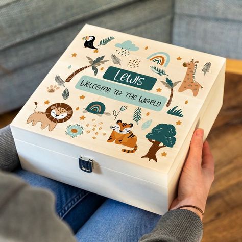 "This personalised new baby keepsake box is the perfect gift to celebrate the arrival of a new baby! The keepsake box is printed with a full colour jungle animals design and includes any personalised text. This keepsake box is ideal for collecting all of those important momentos such as photos and other important items that we wouldn't want to misplace. Often given as part of a new baby, this wooden box can be filled with wonderful gifts and then can be emptied and refilled with special trinkets Newborn Gift Basket, Newborn Gift Boxes, Baby Memory Box, Wooden Wedding Guest Book, Wooden Memory Box, Baby Keepsake Box, Gift For Newborn, Baby Gift Hampers, Animals Design