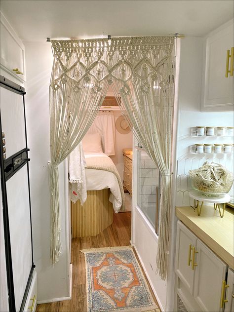 Renovated 1991 RV. White walls, wood floor, porcelain tile shower and kitchen backsplash, wood fluted bed, macrame hanging, linen bedding Hippy Caravan Interior, Boho Camper Ideas, Camper Interior Ideas Boho, Small Rv Interior Design, Modern Boho Camper Interior, 70s Rv Remodel, Boho Camper Bathroom, Vintage Trailer Interior Ideas, Boho Caravan Interior Bohemian