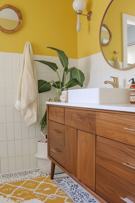 Get ready to infuse your bathroom with warmth, vibrancy, and pure sunshine! These 60+ yellow bathroom ideas are all about adding a splash of color and personality to your daily routine. From vintage-inspired charm to modern twists, we’ve gathered a variety of bathrooms that promise to transform your bathroom into a lively haven. Whether you want to add yellow tile to your bathroom walls, some fun wallpaper, or simply add some yellow decor touches, you'll find something you love on this list! Yellow Mid Century Bathroom, Yellow Toilet Room, Bathroom With Yellow Tile, Yellow Half Bath, Gold Bathroom Walls, Yellow Bathroom Aesthetic, Yellow Tiled Bathrooms, Fun Bathroom Paint Ideas, Yellow And Pink Bathroom