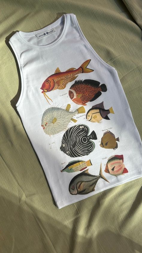 High-Quality Handmade Printed Tank Top- Vibrant and Durable Designs "Louis Renard's Fish, Folio 5 Louis Renard (after Samuel Fallours), 1754" Item details:  -Printing methods: DTG (Direct-to-Garment)  -Location: Produced in Istanbul -Material: 100% cotton Product Features -Ink Type: Made using water-based, eco-friendly pigment inks. These inks offer vibrant and long-lasting colors. -Print Quality:High-resolution prints provide detailed and clear designs. -Durability:The inks deeply penetrate the Fish Shirt Aesthetic, Screen Print Tank Top, Fish T Shirt, Casual Fish Print T-shirt Cheap, Fish Shirt, Graphic Fish Print Short Sleeve T-shirt, Dress Up Boxes, Fun Clothes, Funky Outfits