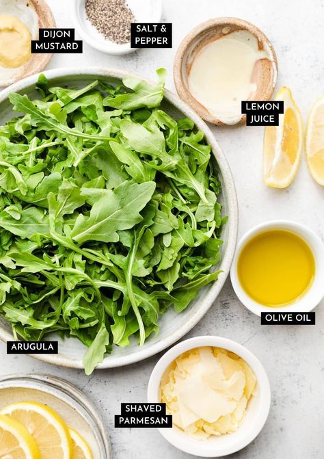 This easy arugula salad is ready in just five minutes! Shake some olive oil, lemon juice, and Dijon mustard together in a jar for a quick dressing, then toss it all up with plenty of fresh arugula and parmesan cheese. Mix it up by adding your favorite cheeses (we like blue cheese, feta, or goat cheese, protein like chicken or salmon, or extra fruits and veggies like avocado, beets, strawberries, or tomatoes. This is a perfect blank canvas salad for a quick, healthy side dish! Vegetarian. Mango Avocado Arugula Salad, Simple Arugula Salad Recipes, Healthy Arugula Salad, Goat Cheese Arugula Salad, Salmon Arugula Salad, Arugula Side Salad, Italian Apps, Argula Salad, Lemon Arugula Salad