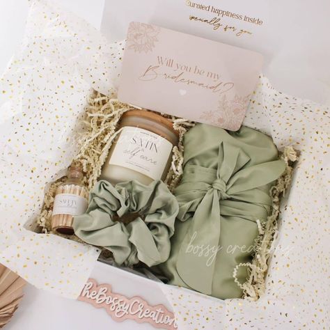 "Indulge yourself and your bridal party in the ultimate self-care experience with our Sage Green \"Satin & Self Care\" Wedding Party Gift Box. Get ready to make unforgettable memories while feeling like royalty on your special day. Slip into the luxurious satin robe, adorned with delicate details, and tie your hair back with the matching satin scrunchie for a picture-perfect look. Create a soothing ambiance with the scented candle, and ignite it with our elegant safety matches.  The magnetic kee Bridesmaid Proposal Green, Green Bridesmaid Proposal, Sage Green Bridesmaid, Scented Candles Luxury, Candle Safety, Safety Matches, Green Bridesmaid, Curated Gift Boxes, Bridesmaid Proposal Gifts