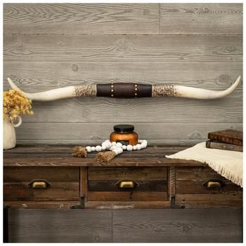 Dimensions: 3.78" H x 40.25" W x 2.44" D Material: Resin Shape: Novelty Color: White, Brown & Gold Pattern: Floral Orientation: Horizontal Includes: 2 Keyhole Slots Quantity: 1 The grit and charm of nature meet in this pair of commanding horns! Longhorn Studded Western Wall Decor is made of resin and is shaped like two long, distressed horns connected at the center by a section that mimics an ornate leather strap. This resin center is embossed with a floral design and metallic gold studs, adding to the horns' country charm. Hang this southwestern beauty in the living room of your ranch house as a rustic statement.   Note: Some assembly is required. Modern Ranch House Decor, Cow Hide Wall Decor Ideas, Large Picture Wall Ideas, Western Living Room Ranch Style, Cowhide On Wall Ideas, Longhorn Skull Decor, Western Office Decor, Rustic Ranch Decor, Ranch Style Decor