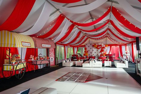 Upon arrival, guests walked through a series of balloon arches featuring orange, white, and red balloons before reaching the unforgettable carnival set up complete with a Ferris wheel, trapeze artists, and authentic carnival games. When the sun began to set, it was time for the show, guests entered the tent decorated with white lounge furniture and red linens matching the streamers on the ceiling. Guests loved watching a unicyclist, dancers, and magic while enjoying their favorite carnival ... White Lounge Furniture, Carnival Treats, Carnival Birthday Theme, Themed Graduation Party, Project Graduation, Outdoor Rehearsal Dinner, Wedding In Puerto Rico, Baby Shower Venues, Halloween Circus