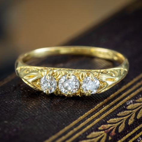 A pretty antique Victorian diamond trilogy ring made in Birmingham in 1863. It’s set with a trio of sparkling old mine-cut diamonds along the front, with superb SI1 clarity – H/I colour, approx. 0.52ct total. The carved half-hoop gallery is modelled in 18ct gold and is engraved with ornate, scrolling motifs down the sides and shoulders, with clear hallmarks within the band. It would make a stunning antique gift for a loved one, with the trilogy of stones representing past, present and futur... Victorian Diamond Ring, Diamond Trilogy Ring, Edwardian Engagement Ring, Trilogy Ring, Antique Diamond Rings, Antique Gift, Sparkling Rings, Diamond Solitaire Engagement Ring, Three Stone Rings