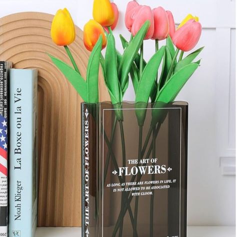 Book Lovers Gifts!! The beautiful vase is designed with the shape and texture of a book, subtly blending cultural art and modern aesthetics, making it easy to fit into any decor space. Perfect for book lovers!

#booktok #flower #decor #homeoffice #bookshelf #books #bookaesthetic #interiordesign #backlist #officegifts #officedesign #desktrinkets #bookends #organization #giftsforher #giftsforwife #giftsforgirlfriend #cutegifts #cheapgifts #bridalshower #weddinggifts #homewarminggifts #housewarming Book About Flowers, Cute Bookshelf, Acrylic Flower Vase, Cute Bookshelves, Vase Cute, Office Decor For Women, Cubicle Decor, Flowers Black, Black Vase