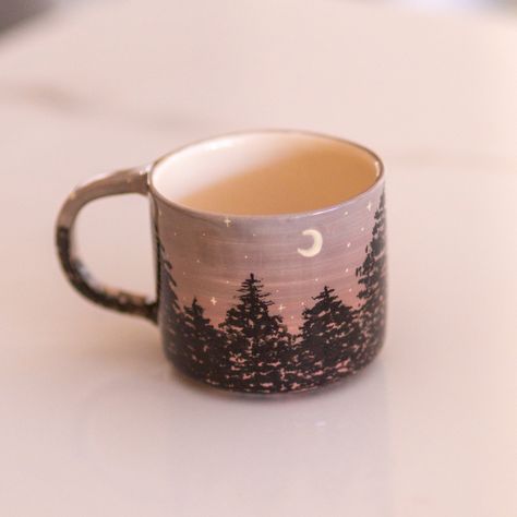 Forest Coffee Mug - Embrace the Mystical Night Theme Indulge in the enchanting ambiance of the night with our Forest Coffee Mug. Handcrafted with meticulous attention to detail, this exquisite mug is a perfect blend of artistry and functionality. With its captivating forest night theme, it brings the mystical allure of nature into your morning coffee routine or evening tea rituals. The Forest Coffee Mug features a beautifully hand-painted design inspired by the serene and captivating night scene