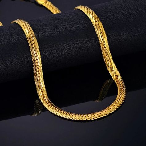 5mm gold herringbone chain necklace for men. This gold-toned 5mm herringbone chain is made of durable stainless steel. The design resembles the chains and necklaces used by the ancient Egyptian pharaohs. The herringbone chain consists of separate flat metal segments that are angled from the middle, forming a herringbone pattern. This type of chain is mostly used by itself, without a pendant. The 5mm width suits perfectly for men who look for a necklace to show off their style. The chain is made Gold Herringbone Chain, Gold Chain Link Necklace, Thick Gold Chain, Thick Necklace, Hip Hop Chains, Necklace Chain Types, Egyptian Pharaohs, Herringbone Chain, Gold Chains For Men