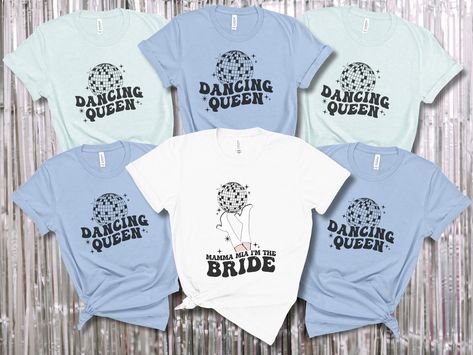 Get ready to boogie the night away at the Mamma Mia Bachelorette Party with our groovy T-shirt set! This must-have ensemble is perfect for the Las Disco Bachelorette who wants to unleash her inner Disco Bride and embrace her role as the ultimate Dancing Queen. The set includes two shirts, one proudly declaring "Bride" and the other exclaiming "Dancing Queen," adorned with dazzling gogo boots and shimmering disco balls. Mamma Mia T Shirt, Mamma Mia Bachelorette Shirts, Dancing Queen Bachelorette Party Outfits, Mama Mia Bachelorette Party Shirts, Mamma Mia Bachelorette Party Shirts, Mama Mia Outfits Bachelorette Party, Mama Mia Bachelorette Party Outfits, Mamma Mia Themed Bachelorette Party, Mamma Mia Bachelorette Party Outfits