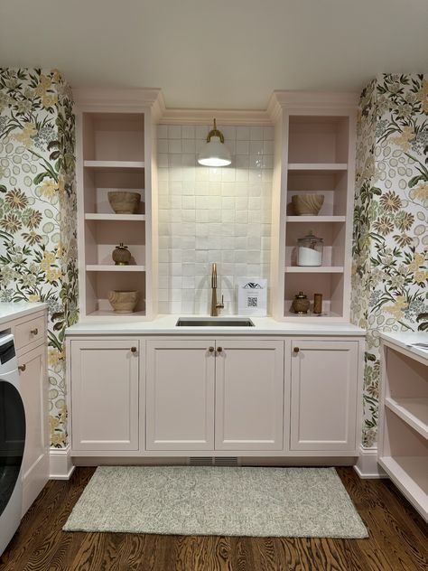 We are absolutely obsessed with this adorable and fun laundry room, featuring pastel pink cabinetry and built-ins, white tile backsplash, and a beautiful floral print wallpaper!!    New Construction | Home Trends 2024 | Home Design | Minnesota Home Trends Whimsical Laundry Room, Laundry Room Inspo, Fun Laundry Room, Perfect Laundry Room, Pink Laundry Rooms, Floral Print Wallpaper, White Tile Backsplash, Minnesota Home, Construction Home