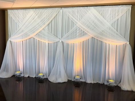 Uplighting on White Pipe and Drape for a local wedding at Valor Hall Conference and Event Center in Oak Grove, KY #wedding #pipeanddrape #uplighting Stage Skirting Decor, Wall Draping Decor, Wedding Wall Draping, Draping Backdrop Ideas, Wall Draping Wedding, Event Center Design, Draping Wedding Reception, Pipe And Drape Wedding, Wedding Draping Backdrop