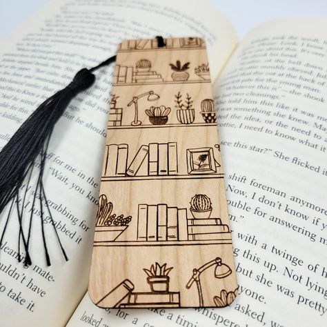 Add a touch of nature to your next novel with these beautiful eco-friendly wooden bookmarks. All bookmarks are engraved in-house using sustainably sourced American hardwood. After your new bookmark is engraved, it is finished with a black bookmark tassel. Best of all, this product is all-natural, so you can feel good about shopping small AND eco-friendly! Material: sustainable American hardwood, unfinished Sizing: 1.7 inch L x 5 inch W Thickness: 1/16 inch Wood Burnt Bookmarks, Wooden Bookmarks Handmade, Diy Wooden Bookmark, Wood Burning Bookmark Ideas, Laser Engraved Bookmarks, Engraving Pen Projects, Woodburning Bookmarks, Woodburn Bookmarks, Simple Wood Burning Designs