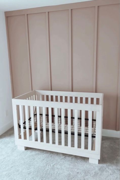 A photo of a board and batten accent wall in the color insightful rose by sherwin Williams as an accent wall in a nursery room for a baby girl Neutral Nursery With White Crib, Vertical Wood Accent Wall Nursery, Rose Pink Accent Wall, Light Mauve Nursery, Nursery Accent Wall Color, Mauve Pink Accent Wall, Rose Colored Nursery, Cabbage Rose Sherwin Williams Nursery, Dusty Pink Baby Nursery