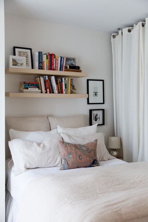 Small Space Storage Ideas from a Brooklyn Apartment | Apartment Therapy Floating Shelves In Small Bedroom, Small Bedroom With Floating Shelves, Floating Shelf Above Headboard, Above The Bed Floating Shelf, Floating Shelf With Books, Floating Shelves For Books Bedroom, Small Bedroom Book Storage, Small Bedroom Wall Shelves, Small Book Storage Ideas