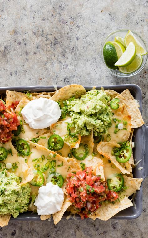 Cheesy Nachos with Salsa. Served with lime wedges, this fresh take on nachos is light-years beyond any fast-food version of cheesy, hot, and fresh nachos. Making Salsa, Best Nacho Recipe, America Test Kitchen, Quick Salsa, Salsa And Guacamole, Cheesy Nachos, America's Test Kitchen Recipes, Illustrated Magazine, Shredded Cheddar Cheese