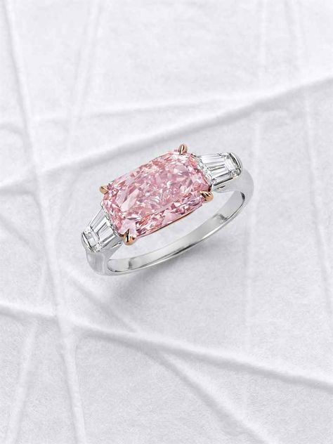 AN EXCEPTIONAL COLORED DIAMOND AND DIAMOND RING. Horizontally-set with a cut-cornered rectangular modified brilliant-cut fancy intense pink diamond, weighing approximately 3.02 carats, flanked on either side by a tapered baguette-cut diamond, ring size 6, mounted in platinum and 18k rose gold. Diamond Rings With Price, Pink Diamond Ring, Pink Bling, Jewelry Photography, Top Drawer, Fancy Color Diamonds, Baguette Cut, Dream Jewelry, Pink Diamond