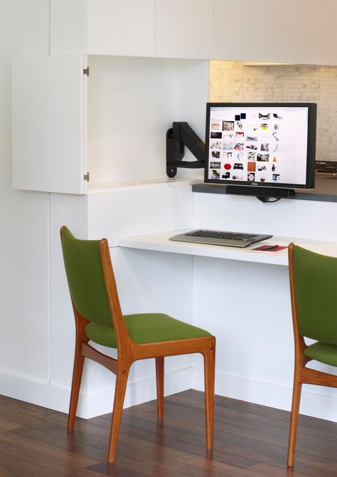 A computer monitor is hidden within the kitchen cabinets, creating a small home office. Hidden Home Office, Kitchen Trends 2020, Modern Wood Desk, Top Kitchen Trends, Kitchen Peninsula, Small Computer Desk, Hidden Kitchen, Rustic Desk, Small Home Office