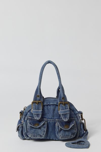 Essential denim bag from BDG with Y2K styling. Mini duffle style with a zippered top and snapped pouch pockets. Trimmed with a hear-shaped mirror charm and finished with a removable crossbody strap. Only at Urban Outfitters. Features. Denim 2000s bag from BDG in a mini silhouette Zipper closure with a removable crossbody strap UO exclusive Content + Care. 100% Cotton Spot clean Imported Denim Y2k Bag, Y2k Duffle Bag, Urban Outfitters Denim Bag, Aesthetic Purses And Bags, Denim Purses And Bags Old Jeans, Bag Out Of Jeans, Cute Bags And Purses, Cool Purses, 2000s Bags